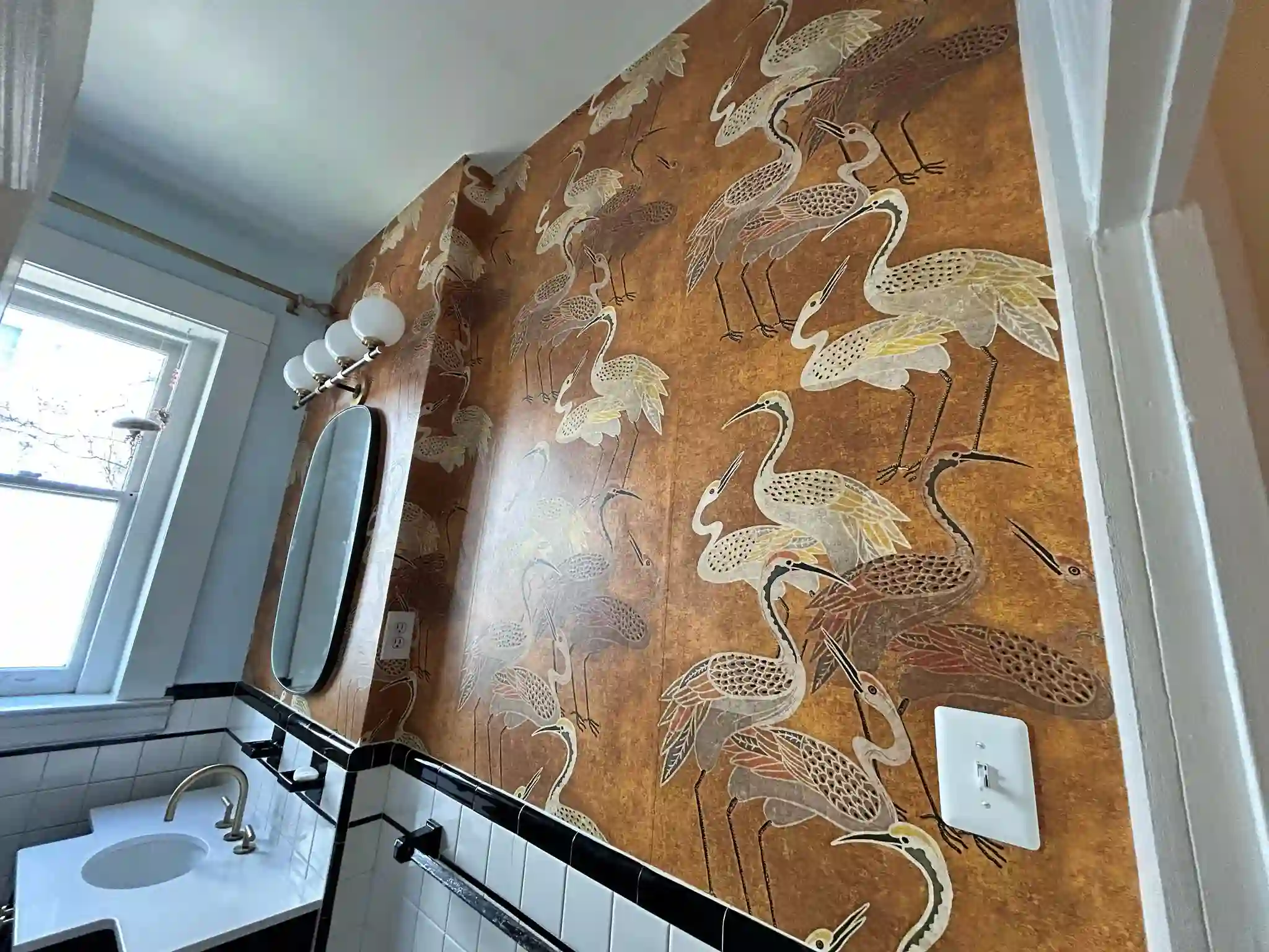 Gold botanical wallcovering with a detailed, repeating motif.