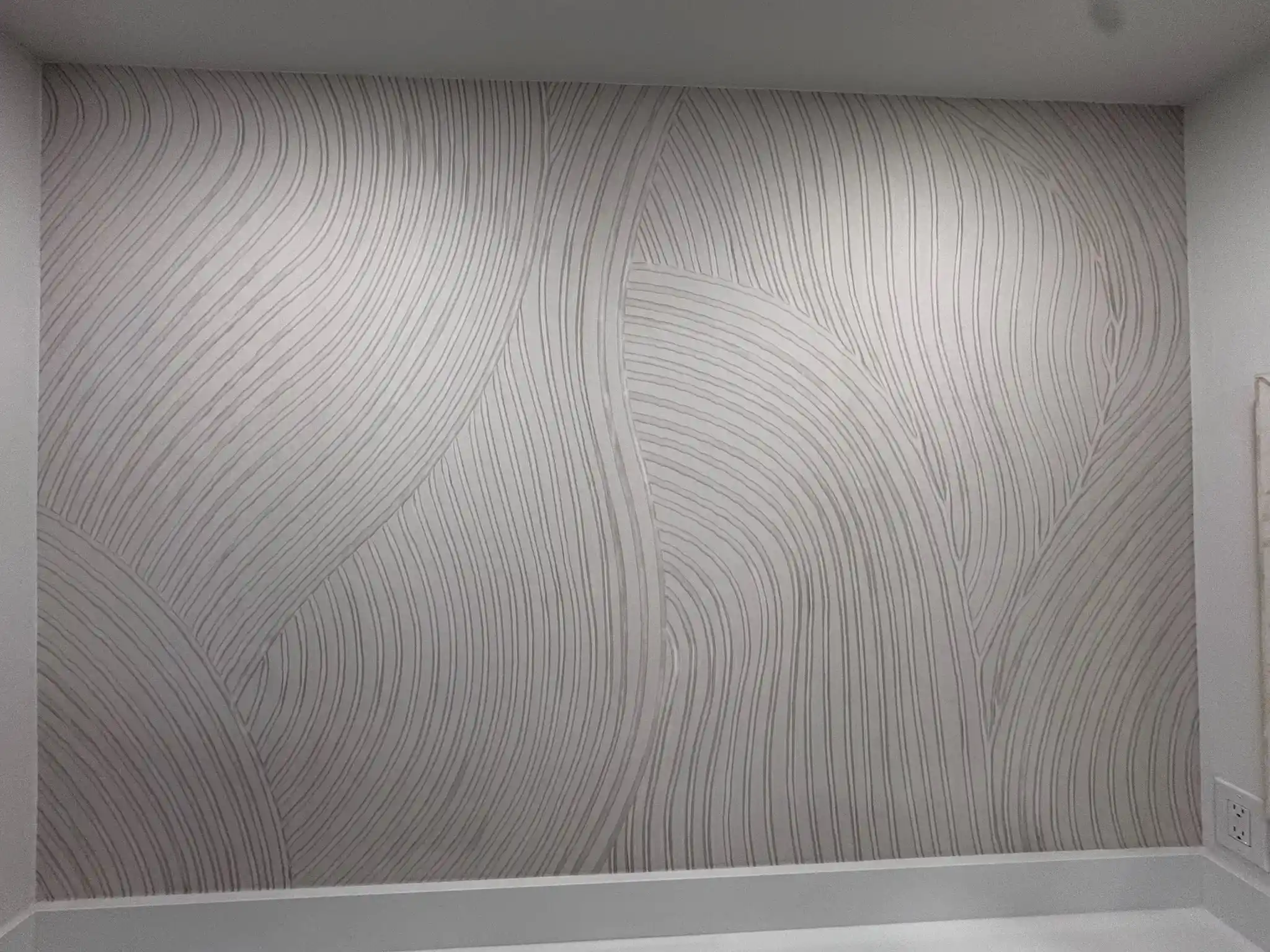 Subtle pale wallpaper texture in a quiet, softly lit corner.